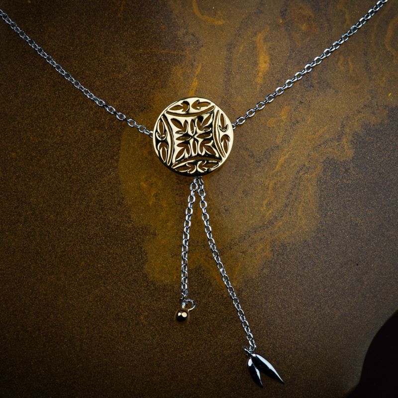 Gold-plated silver medallion necklace with Chinese-inspired detailing.